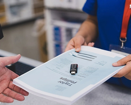  Team member providing copies to a customer