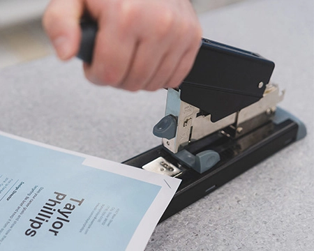 Team member stapling a document